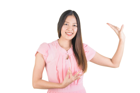 Happy smiling attrative asian young woman in pink dress performing typical thai dance.