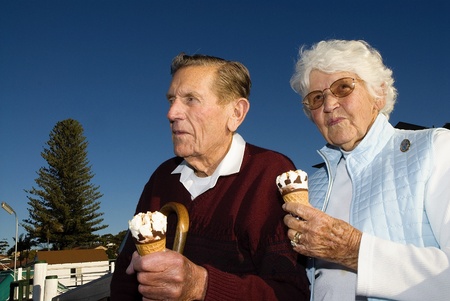 Couple eating an ice cream at the waterfrontの写真素材