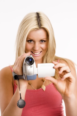 Blond woman films with her camcorderの写真素材
