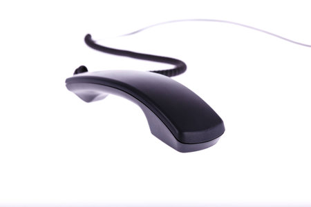 the black phone in front of a white background focus blurの写真素材