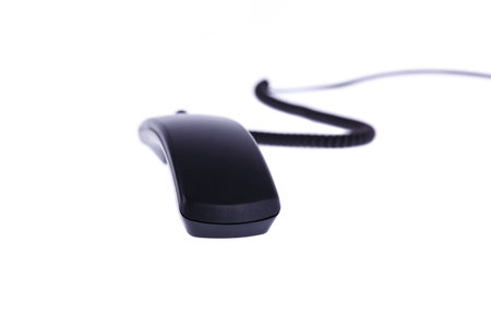 the black phone in front of a white background focus blurの写真素材