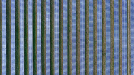Blue Solar panel farm or solar power plantation.  Alternative renewable energy with photovoltaic cell industry. Green energy technology for future world concept, drone point of viewの写真素材