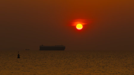 Aerial view Roll on Roll off vehicle car carrier,Seascape and silhouette Roll on Roll off vehicle car carrier floating in sea and over the sunset background,の写真素材