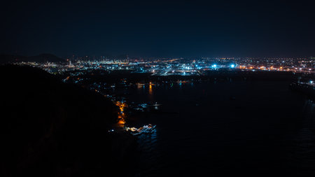 Oil storage tank and oil refinery factory plant at night, Refinery industrial pipeline steel power storage. Oil and Gas petrochemical industrial estate zone. aerial view panoramaの写真素材