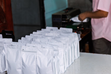 close up of white coffee bag in a row, package process for shipping and retail.
