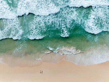 aerial top view of the sea waves  the beach,  play in the sea and sunbathing on the sand beach at surin beach phuket thailand, minimal style.の写真素材