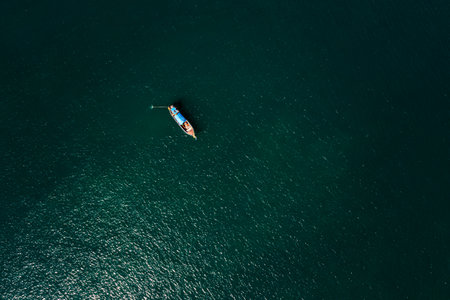 long-tail boat sailing in middle sea. aerial top viewの写真素材