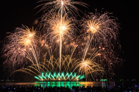 PATTAYA, CHONBURI, THAILAND Beautiful colorful fireworks night scene at Pattaya International Fireworks Festival and silhouette Group of tourist take pictures of firework show on the beach,の写真素材