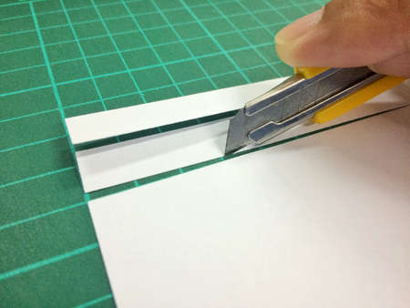 Cut paper with a knife.の写真素材