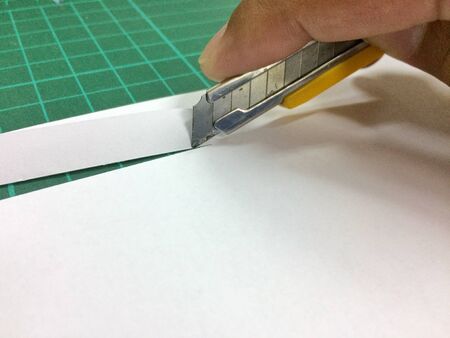 Cut paper with a knife.の写真素材