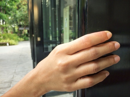 People hand open the door with nature reflection backgroundの写真素材