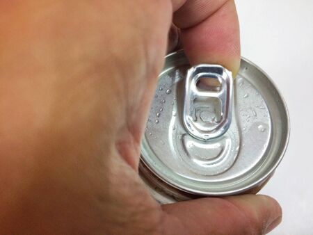 Close up a hand opening cover Aluminum canned drinkの写真素材