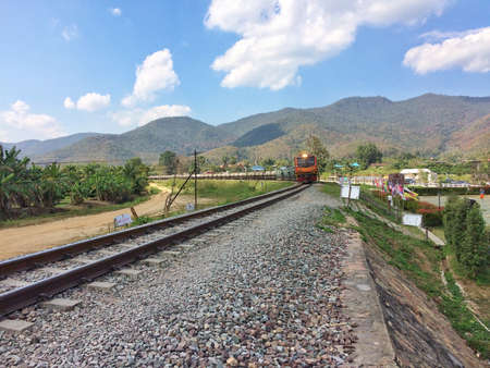 Train running on metal railway with the moutian landscape countryside at Lampang province Northern Thailand.の写真素材