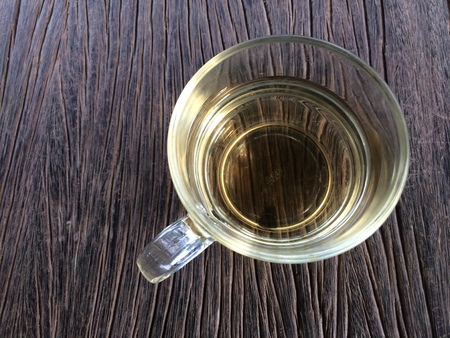 Hot tea in a cup on the wooden table background with morning everydayの写真素材