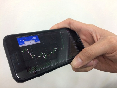 View trade graph chart business people working with on mobile phone.の写真素材