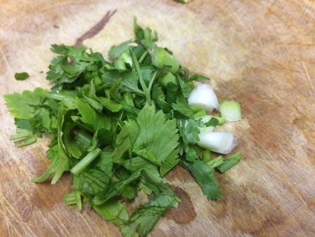 coriander leaf sliced alley on a brown woodenの写真素材
