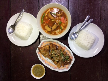 Thai food Deep Fried Sea Bass Fish Sauce and Sour curry with vegetable and rice dishes.の写真素材