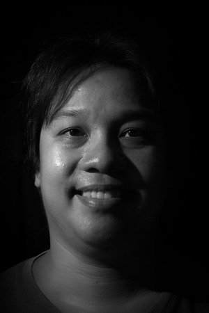 Man smiling isolated on black backgroundの写真素材