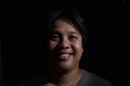 Man smiling isolated on black backgroundの写真素材