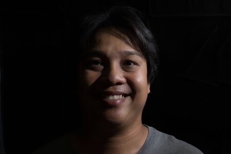 Man smiling isolated on black backgroundの写真素材