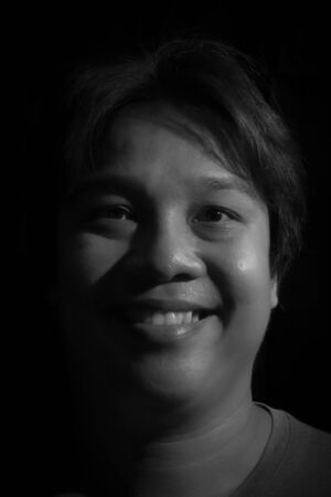 Man smiling isolated on black backgroundの写真素材