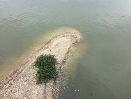 High angle view of sand dunes and sea waterの写真素材