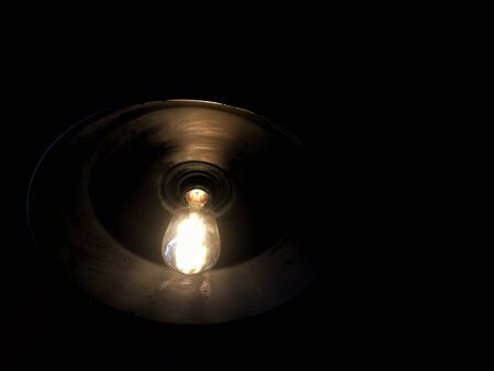 Bright light lamp on black backgroundの写真素材
