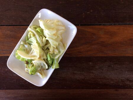 Stir-fried cabbage in a white plateの写真素材