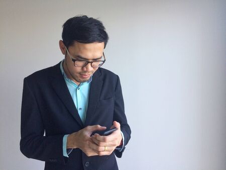 Businessman using mobile phone outside of office. man holding smartphone for business work.の写真素材