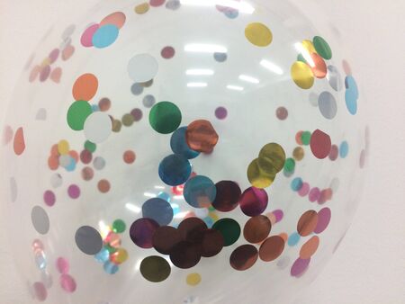 Transparent balloon with many small colored circles inside the balloon.の写真素材