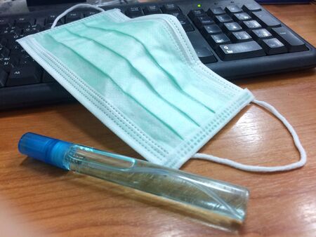 Mask and alcohol in bottles to use for cleaning injections to use while working.の写真素材