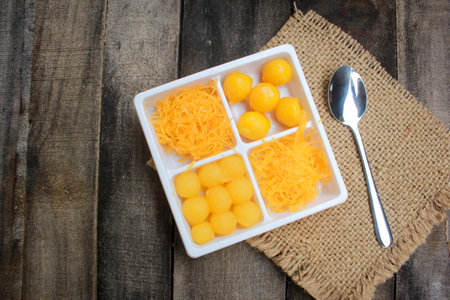 Beautiful Thai desserts placed on wooden floor.の写真素材