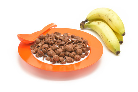 Isolated cereal on orange dish and bananasの写真素材