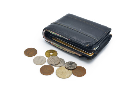 isolated old used leather wallet and coins on white backgroundの写真素材