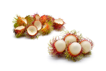 Isolated eating and eaten rambutan fruits on white backgroundの写真素材
