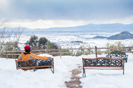 Man sit on armchair from behind on Hachiman mountain in Omihachiman city, Kyoto prefectureの写真素材