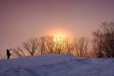 Sunset view on the top of Moiwa mountain in winter snowの写真素材