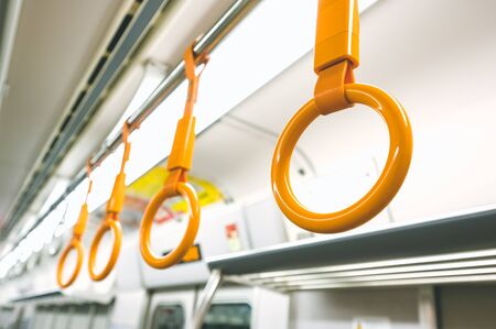 Yellow handrails in Japan train, selective focusの写真素材