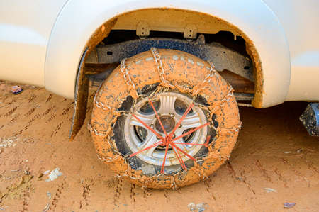 Wheel of a car with mounted mud chainsの写真素材