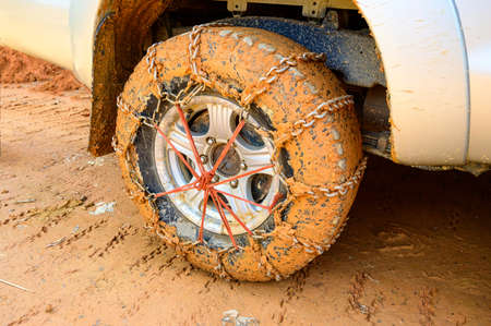Wheel of a car with mounted mud chains