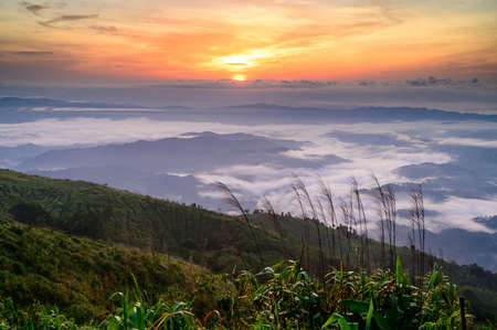 Sunrise behind mountain view at Doi Suan Ya Luang, Ban San Charoen district, Nan province, Thailandの写真素材