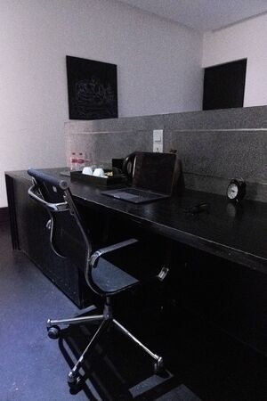 office space with laptop and clock and tea making setの写真素材