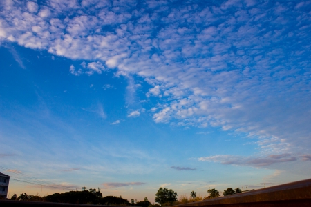 white fluffy clouds in the blue sky の写真素材