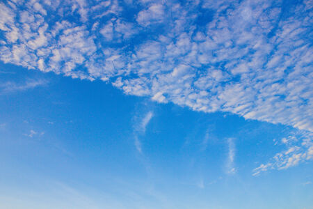 white fluffy clouds in the blue sky の写真素材