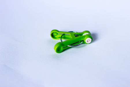 green clothes peg isolated on a white background.