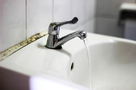 Water drop from faucet in Bathroom