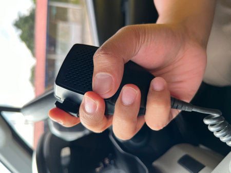 Close up of hand of a man driving a car using a mobile phone