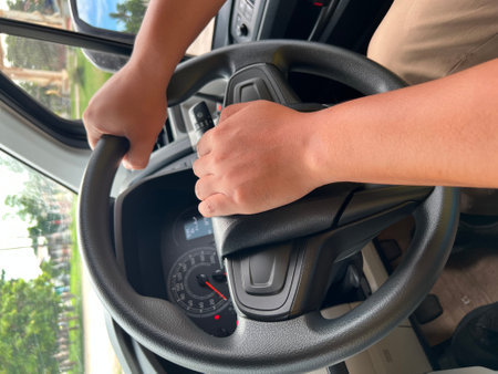 Man driving a car. Close-up of hands on steering wheel