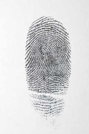 Black fingerprint on white paperの写真素材