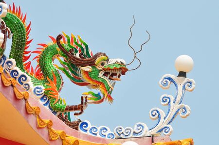 Green dragon statue with blue skyの写真素材